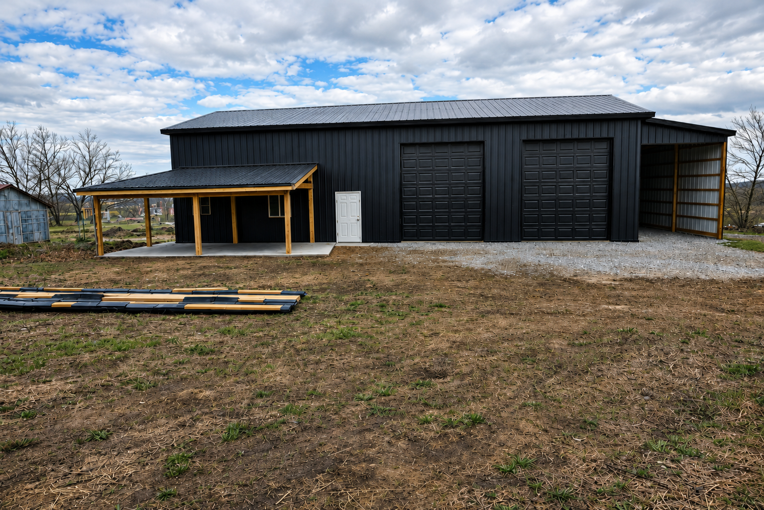 Black post-frame shop with lean-to