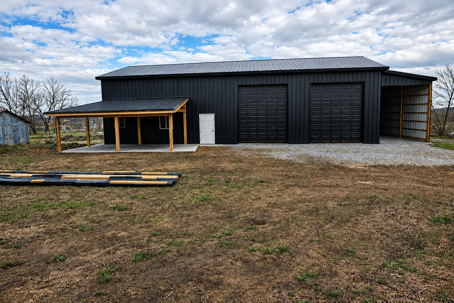Black post-frame shop with lean-to