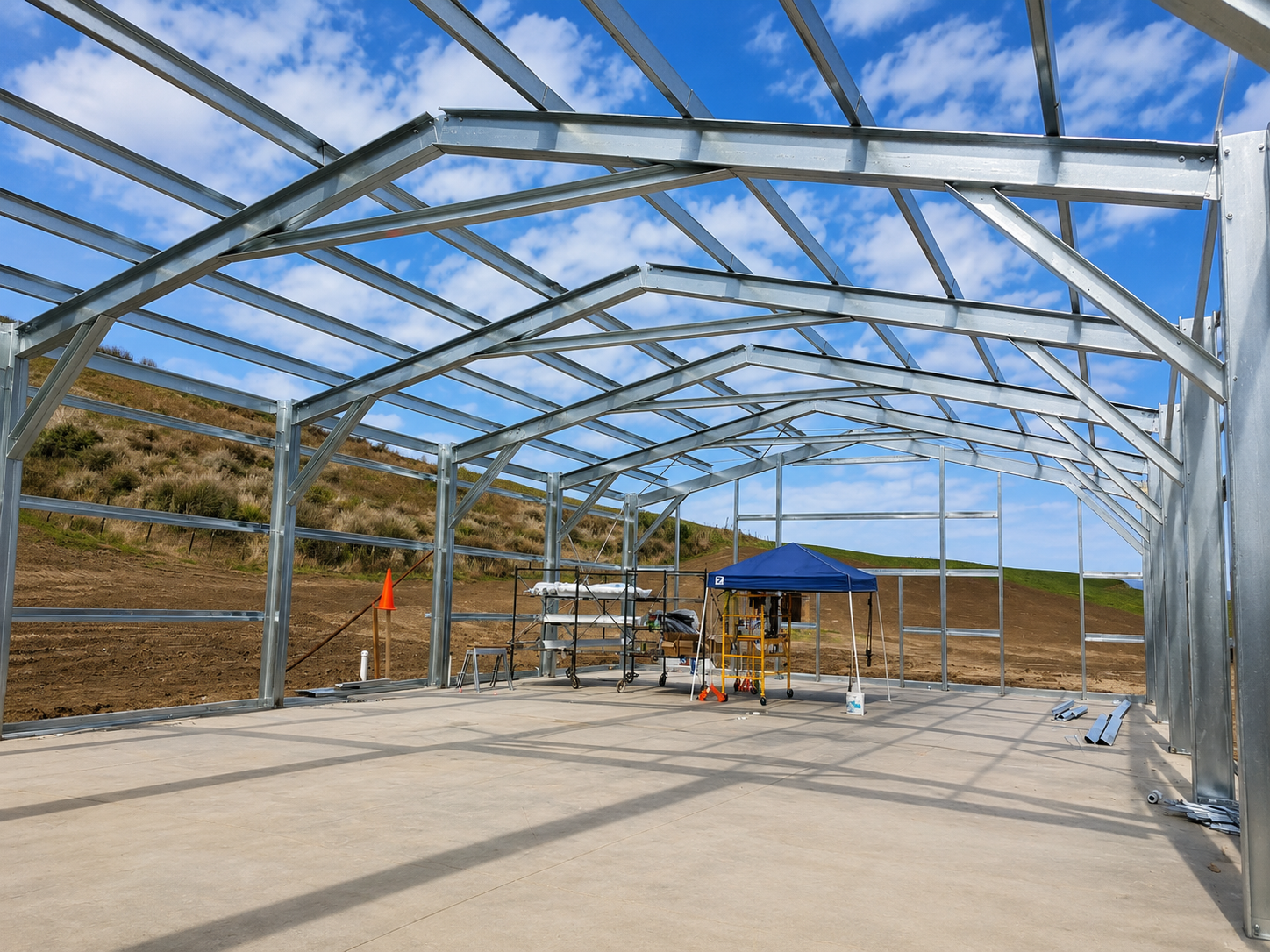 Interior cold-form steel arch framing against blue sky